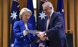 La présidente de la Commission européenne Ursula von der Leyen et le Premier ministre australien Anthony Albanese échangent des copies de l'accord commercial Australie-UE, le 24 mars 2026 à Canberra