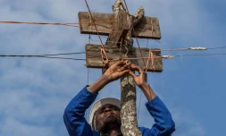 Electricien autoditacte, Colrerd Nkosi contrôle le 23 août 2021 la ligne électrique qui alimente son village de Yobe Nkosi, dans le Nord du Malawi, depuis une petite centrale hydro-électrique artisanale qu'il a installée