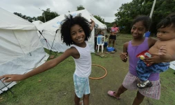 Des enfants  devant les tentes d'un camp de sinistrés à Pedernales