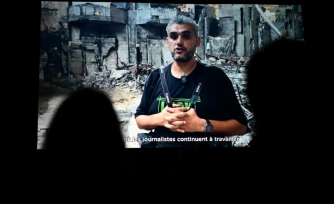 Le photographe palestinien Mahmoud Abu Hamda prononce un discours préenregistré, diffusé sur écran, aprÚs avoir reçu le prix du jury international de l'édition 2026 du Prix Bayeux Calvados-Normandie des correspondants de guerre, à Bayeux, le 10 octobre 2026
