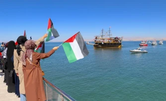 Des sympathisants saluent le passage de bateaux de la Flottille pour Gaza, le 5 octobre 2025, à Van (Turquie). (EMRE ILIKAN / ANADOLU / AFP)