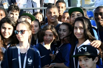 Kylian Mbappé (c) pose avec des jeunes supporters de Bondy, commune du club de son enfance, à la fin d'un entraînement lors du Mondial, le 27 juin 2018 à Istra   