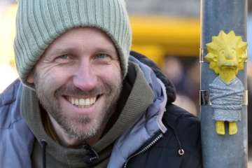 Mihaly Kolodko à coté d'une de ses petites statues "Lisa", un personnage des Simpsons, à Budapest, le 11 décembre 2019