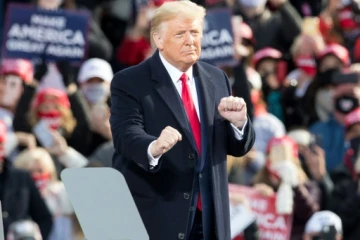 Donald Trump dances on stage to the Village People's 'YMCA' at the end of a campaign rally in October 2020