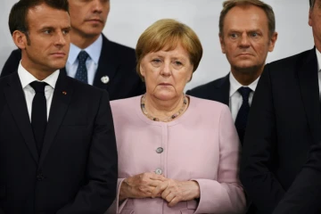 Le président français Emmanuel Macron, la chancelière allemande Angela Merkel et le président du conseil Donald Tusk lors du sommet du G20 à Osaka le 29 juin 2019