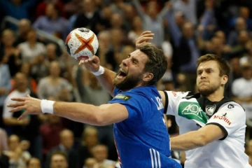 Luka Karabatic (g) à la lutte avec l'Allemand Fabian Boehm lors du Mondial, à Berlin, le 15 janvier 2019  