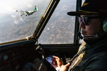 Des pilotes d'avions du service royal thaïlandais des précipitations, participent à une mission de modification atmosphérique visant à déplacer la pollution en pulvérisant de l'eau glacée dans l'air, le 15 janvier 2025 à la périphérie de Bangkok