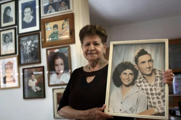 Yona Musa, 76 ans, d'origine yéménite, pose avec un portrait d'elle et son mari le 29 juin 2016 à Herzliya, près de Tel Aviv