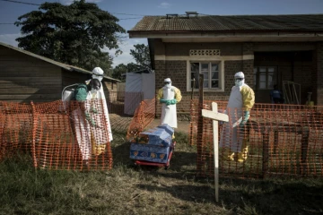Le personnel médical désinfecte le cercueil d'une personne décédée, un cas non confirmé d'Ebola, le 13 août 2018 à Beni (RDC)
