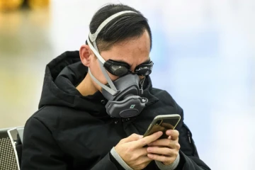 Un passager avec des lunettes de natation et un masque à la gare de Hong Kong qui relie ce territoire à la Chine continentale, le 28 janvier 2020 