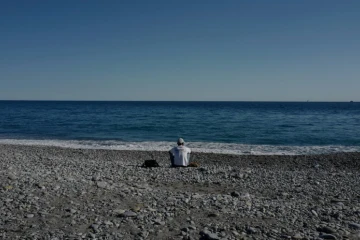 Une personne migrante sur la plage, à Vintimille, le 5 août 2020, après que le Centre de la Croix-Rouge qui hébergeait les candidats à la traversée de la frontière italo-française a été fermé