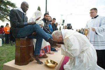 Photo fournie par les services de presse du  Vatican montrant le pape François accomplissant le rituel du lavement des pieds au centre d'accueil pour migrants à Castelnuovo di Porto, près de Rome, le 24 mars 2016
