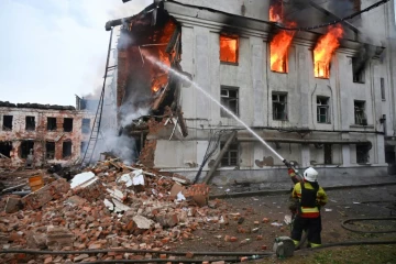 Un pompier lutte contre un incendie dans un bâtiment après une série d'attaques russes contre la ville de Kharkiv, dans l'est de l'Ukraine, le 7 juin 2025