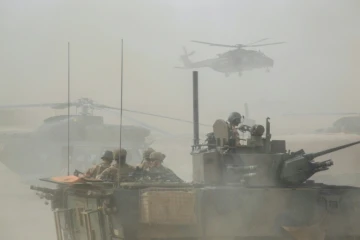 Un blindé et des hélicoptères militaires français de l'opération Barkhane le 27 mars 2019 dans la région malienne de Gourma