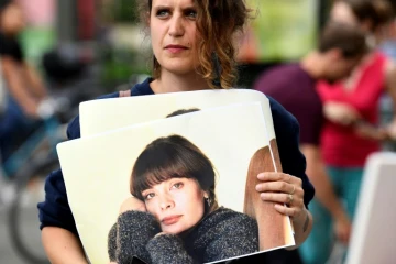 Une femme porte le portrait de Marie Trintignant lors d'une manifestation devant le Zenith à Paris où se produit Bertrand Cantat, le 7 juin 2018