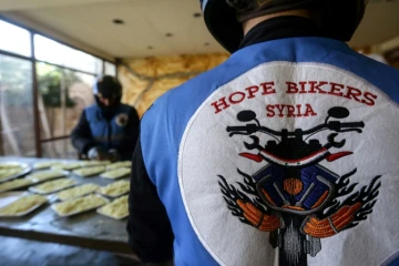 Des membres du club de motards "Hope Bikers Syria" préparent la distribution de repas aux personnes dans le besoin pendant le ramadan, le 25 mars 2024 à Damas, en Syrie