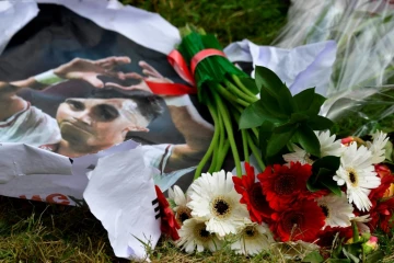 Des gerbes de fleurs et le portrait d'Abdelhak Nouri devant l'hôpital d'Amsterdam, où le milieu de l'Ajax est soigné le 22 juillet 2017