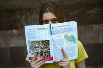 Andjela Babovic, lycéenne à Belgrade, montre les pages d'un livre d'Histoire, le 24 juin 2016 dans la capitale serbe