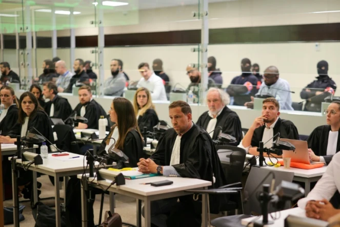Les accusés sont assis dans un box vitré, derrière leur avocat, dans la salle d'audience, pendant l'annonce du verdict du procès de l'attentat terroriste de Bruxelles, au Palais de justice de Bruxelles, le 25 juillet 2023