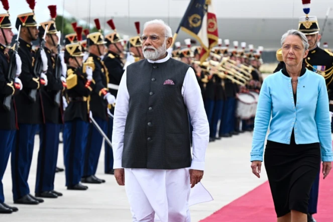 La Première ministre Elisabeth Borne et son homologue indien Narendra Modi (g) passent en revue la garde républicaine à l'aéroport d'Orly, le 13 juillet 2023 près de Paris