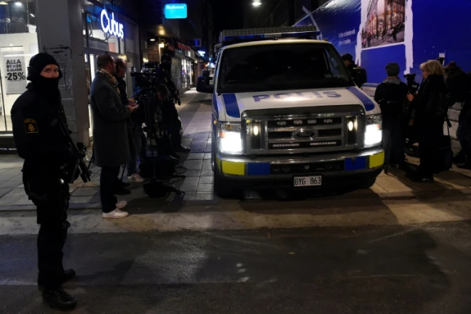 Policiers et journalistes sur les lieux de l'attaque au camion bélier dans le centre de Stockholm, le 7 avril 2017
