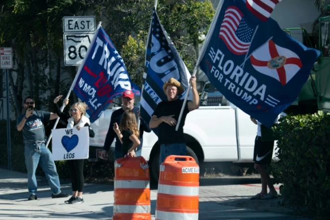 Des sympathisants du président américain  Donald Trump saluent le passage du convoi présidentiel à West Palm Beach, en Floride, le 27 décembre 2020