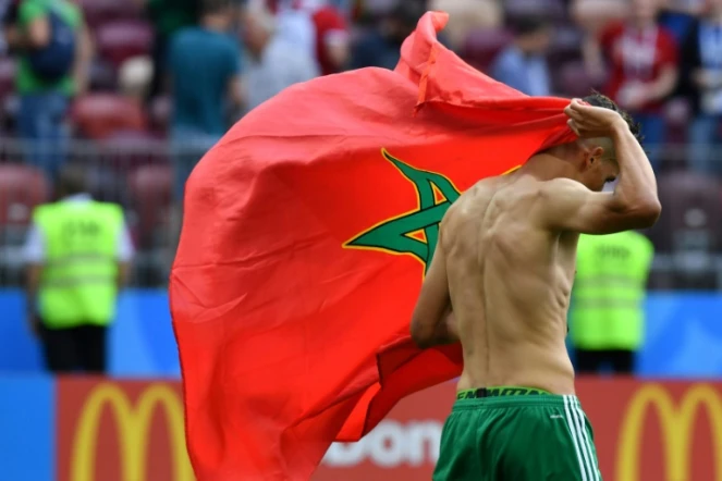 Le milieu de terrain Fayçal Fajr quitte la pelouse avec le drapeau marocain sur le dos, après l'élimination de son équipe du Mondial, battue par le Portugal le 20 juin 2018 à Moscou