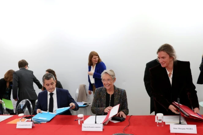 La Première ministre Elisabeth Borne (C) et le ministre de l'Intérieur Gérald Darmanin participent au 3e Comité interministériel à l'enfance, le 20 novembre 2023 à Paris