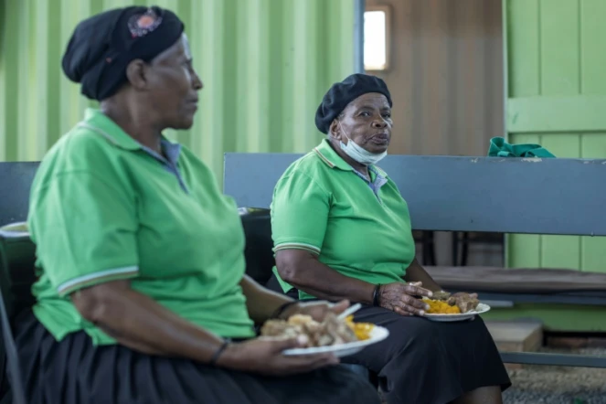 Des résidentes d'une maison de retraite mangent un repas préparés à partir d'invendus, le 17 février 2021 à Johannesburg, en Afrique du Sud