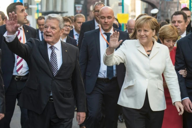 La Chancelière allemande Angela Merkel et le président Joachim Gauck saluent la foule, le 3 octobre 2015 à Francfort, à l'occasion des 25 ans de la Réunification de l'Allemagne