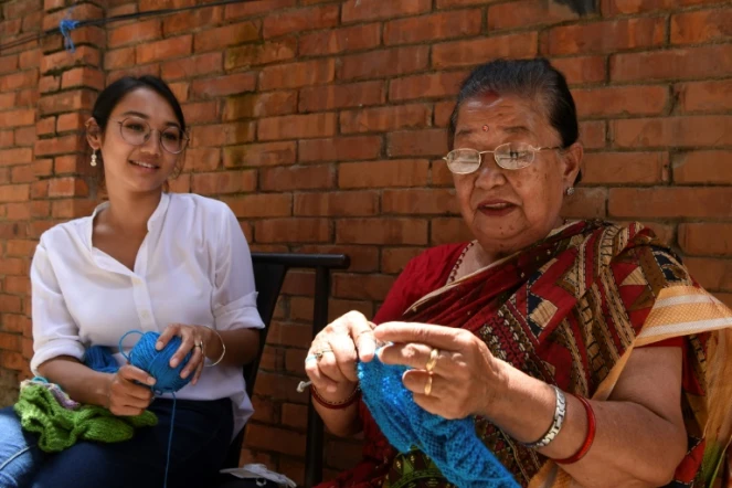 Lorina Sthapit et sa grand-mère Champa Devi Tuladhar qui tricote des chaussettes lors d'une interview avec l'AF, le 6 août 2020 à Katmandou, au Népal