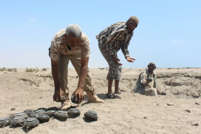 Des forces armés yéménites inspectent un lot de mines confisquées aux rebelles chiites huthis, avant de les neutraliser, dans le désert d'al-Alam, à l'est d'Aden, le 10 mars 2016