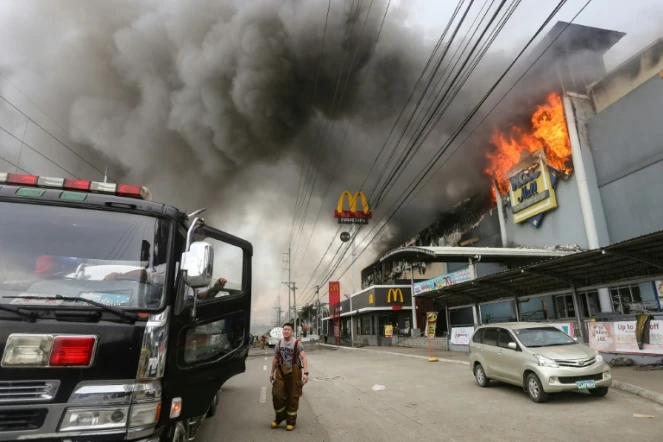 Un pompier devant un centre commercial de Davao le 23 décembre 2017