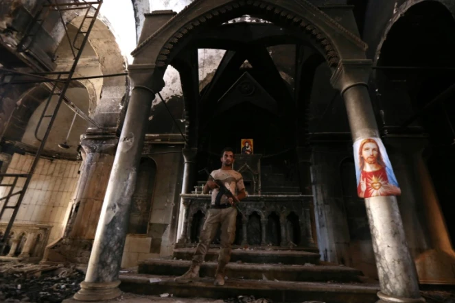 Un membres des forces chrétiennes irakiennes dans l'église de l'Immaculée Conception le 30 octobre 2016 à Qaraqosh, à 30 kms de Mossoul, reprise au groupe Etat islamique