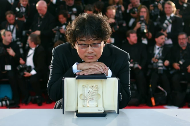 South Korean director Bong Joon-Ho with the trophy after he was awarded the Palme d'Or at Cannes for his film "Gisaengchung", or "Parasite"