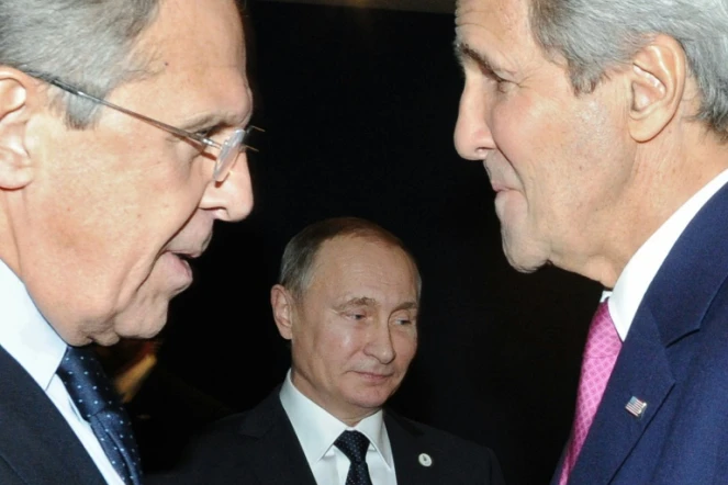 Le ministre russe des Affaires étrangères, Sergueï Lavrov (g) et son homologue américain John Kerry (d) discutent devant le président russe Vladimir Poutine (c), à Paris le 30 novembre 2015