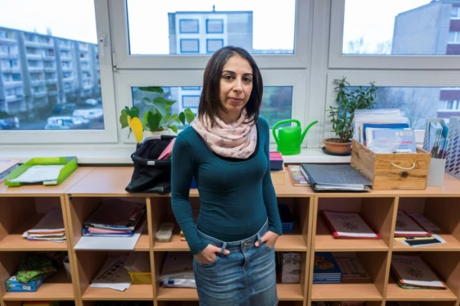 La Syrienne Hend Al Khabbaz, qui enseignait l'anglais dans son pays avant de le fuir, pose dans une classe de l'école Sigmund Jähn à Fürstenwalde, dans l'est de l'Allemagne, où elle travaille désormais, le 19 janvier 2018.