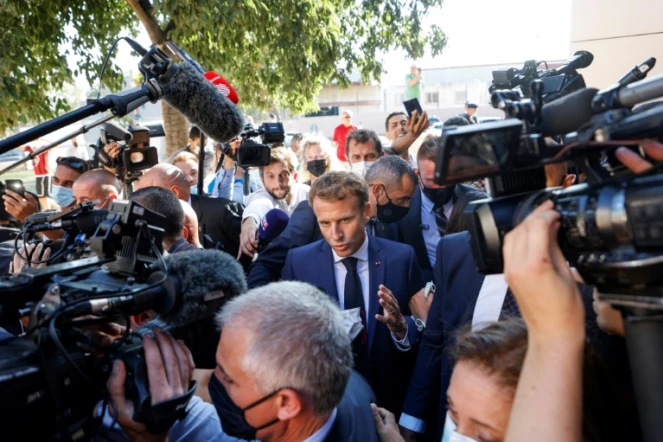 Le président français Emmanuel Macron marche entouré  des médias dans le quartier de Bassens au premier jour d'une visite de trois jours à Marseille, le 1er septembre 2021