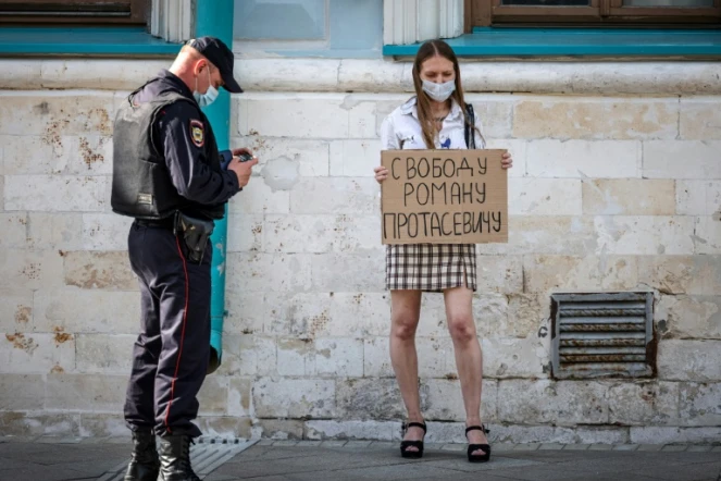 Une jeune femme brandit une pancarte "Liberté pour Roman Protassevitch" devant l'ambassade du Bélarus à Moscou le 25 mai 2021