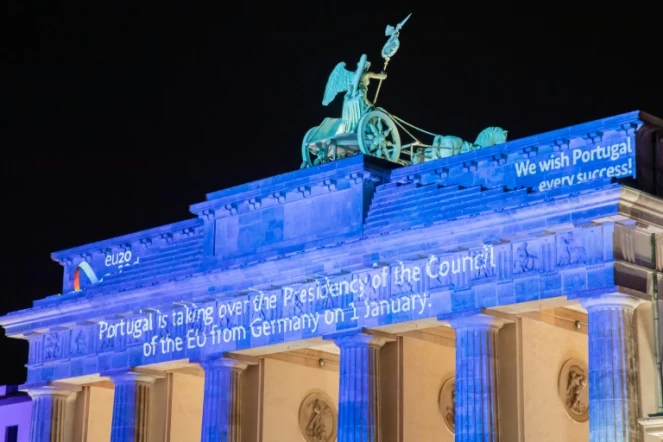 La porte de Brandebourg à Berlin illuminée pour marquer la fin de la présidence allemande et le début de la présidence portugaise de l'UE, le 31 décembre 2020 à minuit
