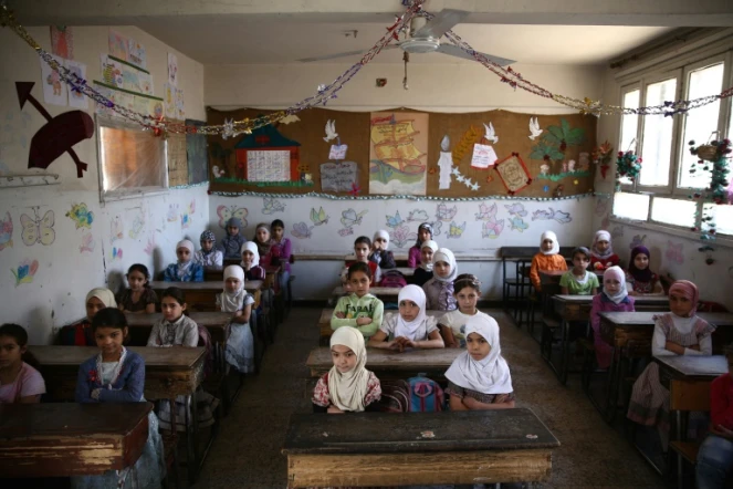 Des Syriennes écoutent leur professeur lors d'une classe à l'école Saif al-Dawla à Douma en Syrie le 25 mai 2016