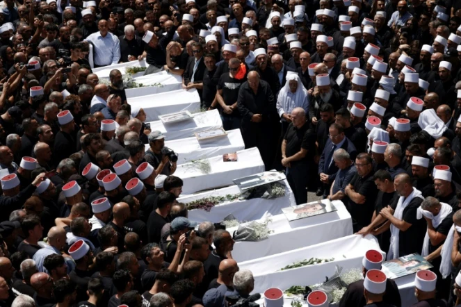 Funérailles des victimes d'une frappe imputée au Hezbollah libanais sur le plateau syrien du Golan annexé, dans la ville druze de Majdal Shams le 28 juillet 2024