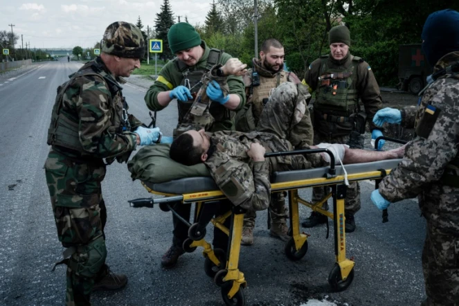 Des soldats ukrainiens évacuent un blessé près de Lyssytchansk, dans l'est de l'Ukraine, le 10 mai 2022