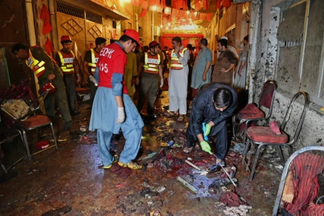 Les autorités et des volontaires sur le site de l'attaque suicide à Peshawar, le 10 juillet 2018