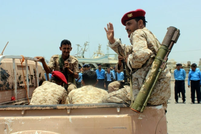 Un rebelle Houthi fait un signe de la main lors du retrait annoncé de troupes rebelles du port de Salif, au Yémen, le 11 mai 2019