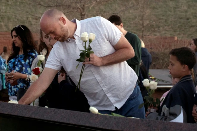 Will Beck, un des rescapés du massacre, plaçant des fleurs sur le mémorial érigé pour les 20 ans de Columbine