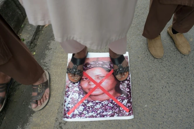 Le portrait de la chrétienne Asia Bibi, accusée de blasphème, et condamnée à mort, est barré d'une croix rouge et piétinée lors d'une manifestation contre son acquittement par la Cour suprême, le 2 novembre 2018 à Islamabad, au Pakistan