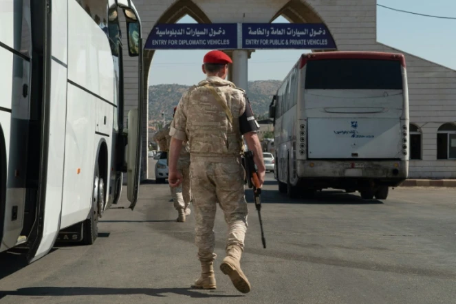 Un bus transportant des réfugiés syriens de retour du Liban, le 13 août 2018, à Jdaidat Yabous, en Syrie