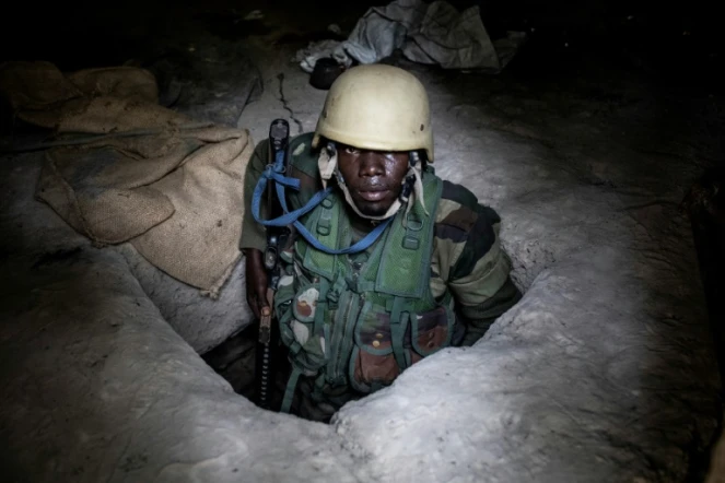 Un militaire sénégalais sort d'un bunker souterrain d'une base récemment prise aux rebelles du Mouvement des Forces démocratiques de Casamance (MFDC) dans la forêt de Blaze, le 9 février 2021