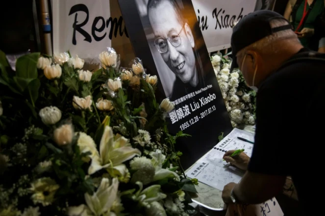 Un homme écrit un message sur le livre de condoléances après la mort du dissident chinois et Nobel de la Paix 2010 Liu Xiaobo, le 13 juillet 2017 à Hong Kong
